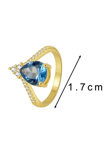 Macro detail of gold vintage ring with blue pear-cut zircon and 1.7cm size dimension