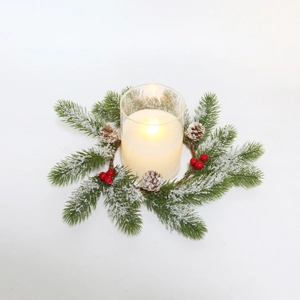 Christmas candle ring with frosted pine needles, red berries, pine cones and glass jar