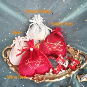 Romantic heart-shaped velvet gift bags with golden text in four assorted colors