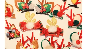 Detailed flat lay of Christmas antler hair clips with mink fur and festive decorations