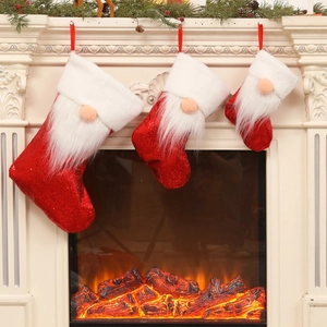 Three sequined Christmas stockings with gnomes hanging on a festive fireplace mantel
