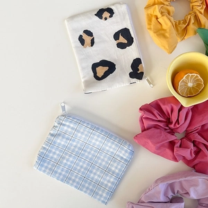 Detail of blue plaid and leopard print cotton coin purses with colorful hair scrunchies