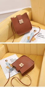 Vue détaillée du petit sac carré en cuir grainé marron avec fermoir tournant doré