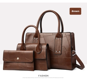 Three-piece brown bag set with crocodile texture including tote, shoulder bag and wallet
