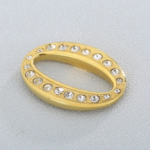 Minimalist golden stainless steel oval pendant with clear cubic zirconia inlay on grey surface