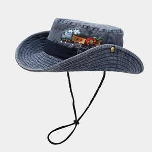 Detail of cartoon train embroidery and Happy Smile text on washed denim sun hat