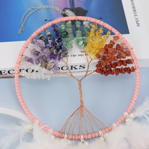 Detail of life tree dream catcher with colorful natural crystals and white feathers