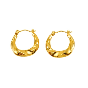 Detailed close-up of golden spiral twisted hoop earrings with a polished metal finish