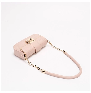 Close-up of pink croc-effect crossbody bag with gold hardware and chain strap details