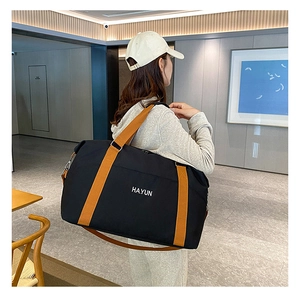 Detail of high-capacity yoga fitness travel bag with HAYUN print and orange straps