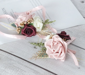 Detail of elegant silk rose corsage and wristlet with pink ribbons for weddings