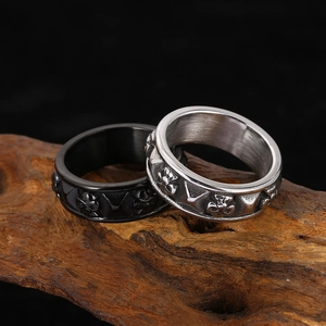 Vintage punk skull and cross relief rings in black and silver steel on wood