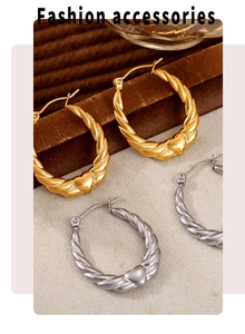Detailed shot of twisted heart-shaped hoop earrings in gold and silver stainless steel