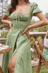Detail of square neckline with drawstring and puff sleeves on green floral maxi dress