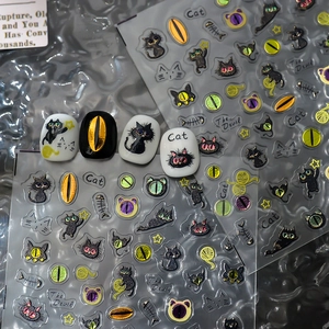 Detail of 3D embossed black cat and fishbone nail art stickers on display tips