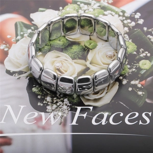 Polished silver hematite beads bracelet detail on fashion magazine background