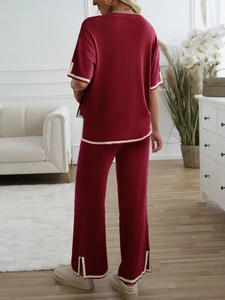 Rear view of red knitted two-piece set with short sleeve top and wide leg pants