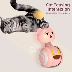 Pink tumbler cat toy with bear design and yellow feather ball for interactive rolling play