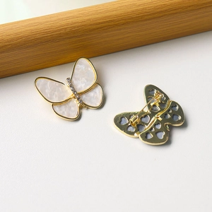 Elegant butterfly brooch with pearl wings and gold metal frame showing front and back views