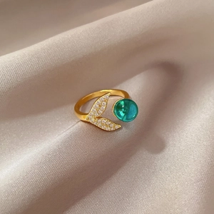 Golden mermaid tail open ring with green crystal and sparkling zircon accents