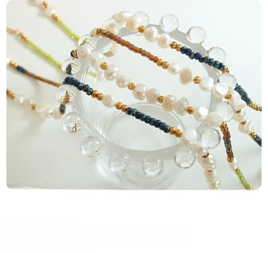 Detail of layered Bohemian necklace with freshwater pearls and colorful glass beads