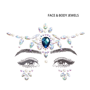 Close-up of crown-shaped face jewels with blue teardrop stone and pearls for festivals