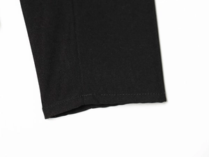 Detailed close-up of high-quality black twill fabric stitching on a tailored blazer