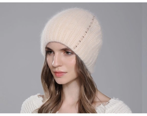 Detailed view of knitted rabbit fur hat with elegant pearl and rhinestone accents