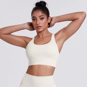 Detail of cream brushed sports bra with crisscross back and wide hem for yoga