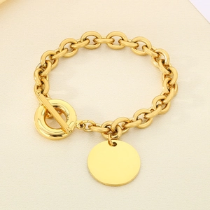 Detailed view of golden 9mm chain bracelet with toggle clasp and blank round tag