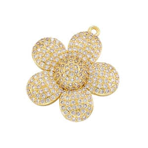 Close-up of gold-plated sunflower pendant with micro-paved sparkling cubic zirconia