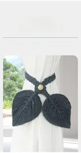 Detail of dark grey handmade macrame curtain tieback with double leaf design and wood bead