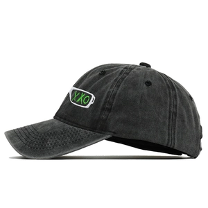 Detail of dark grey washed cotton baseball cap with green XXO embroidery and bottle motif
