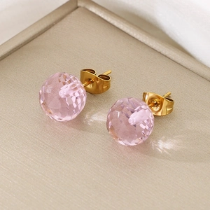Macro shot of faceted pink crystal stud earrings with gold-plated titanium steel backings