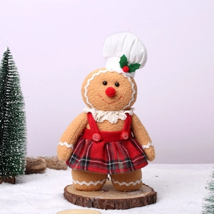 Gingerbread man plush Christmas gnome in red plaid dress and chef hat on snow base