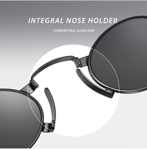 Detail of ergonomic integral nose pads on black punk metal oval sunglasses