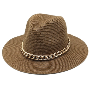 Detail of dark brown straw sun hat featuring a bold gold metal chain and fine weave