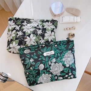 Close-up of vintage floral jacquard cosmetic bags with zipper and texture detail