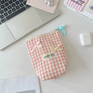 Detail of red checkered pouch featuring cute pink bows and soft seersucker texture