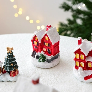 Miniature red Christmas resin house model with snowy tree and festive decorations