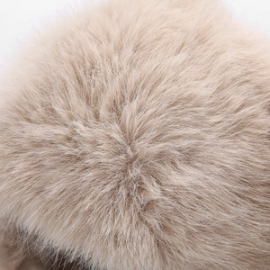 Close-up of soft beige faux fur pom-pom detail on the thermal rabbit ear beanie hat