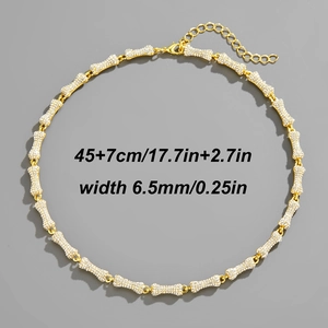 Detailed view of 6.5mm gold bone chain with measurements of 45cm plus 7cm extender