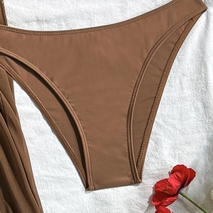 Detailed view of coffee brown bikini bottoms with premium elastic fabric and flat seams
