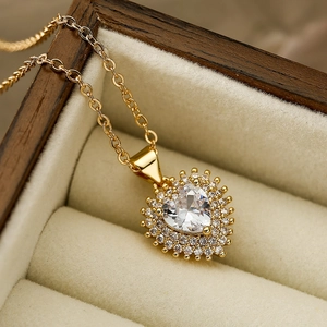 Elegant gold heart pendant necklace with clear zircon in a premium wooden jewelry box