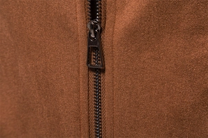 Detailed close-up of a premium black metal zipper on a brown suede texture jacket