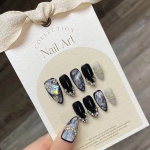 Dark marble almond press-on nails with luxury black finish and silver sequins