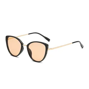 Retro cat-eye sunglasses with black frames, gold metal temples, and light orange lenses