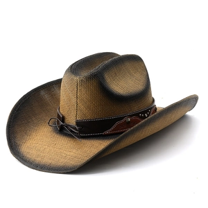 Detail of hand-woven gradient straw hat with studded leather band and vintage metal rivets