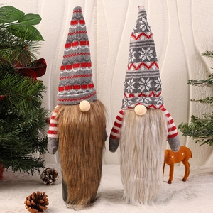 Detail of Christmas gnome wine bottle covers with knitted hats and faux fur beards