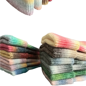 Multiple color options of chunky tie-dye gradient knit beanies stacked neatly
